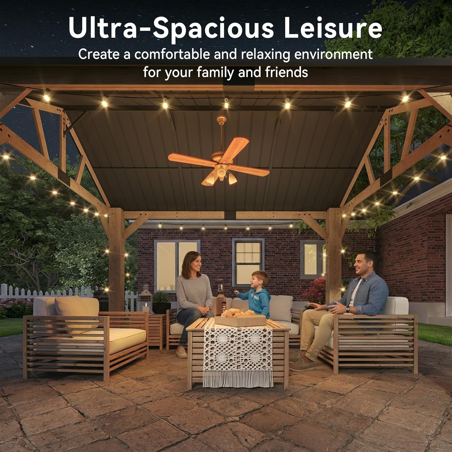 Centered nighttime view under the gazebo showing a family chatting around a low coffee table on a stone patio.