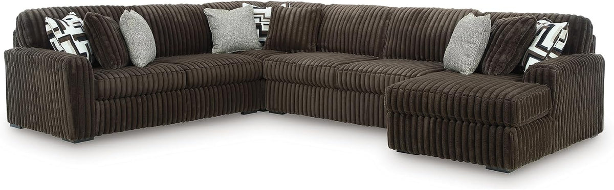 Three-piece oversized sectional in chocolate brown jumbo corduroy with throw pillows, right-side chaise.