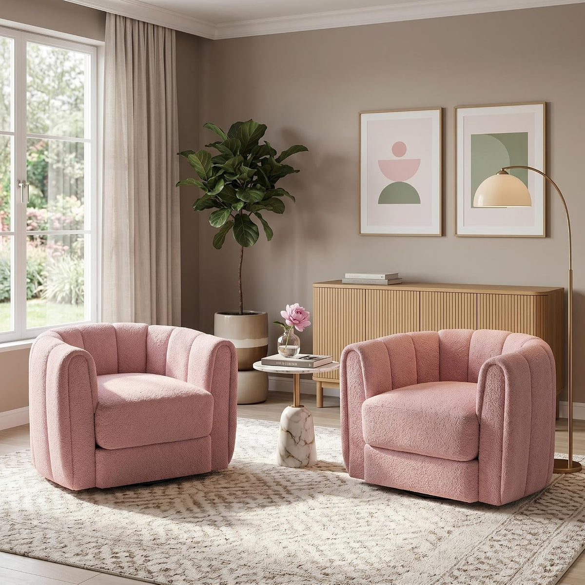 Two pink rounded barrel swivel chairs facing forward in a softly lit living room with wood credenza.