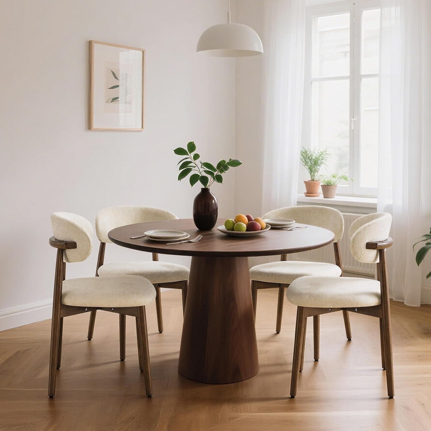 Four ivory-speckled curved-back chairs surround a round table in a bright dining room.