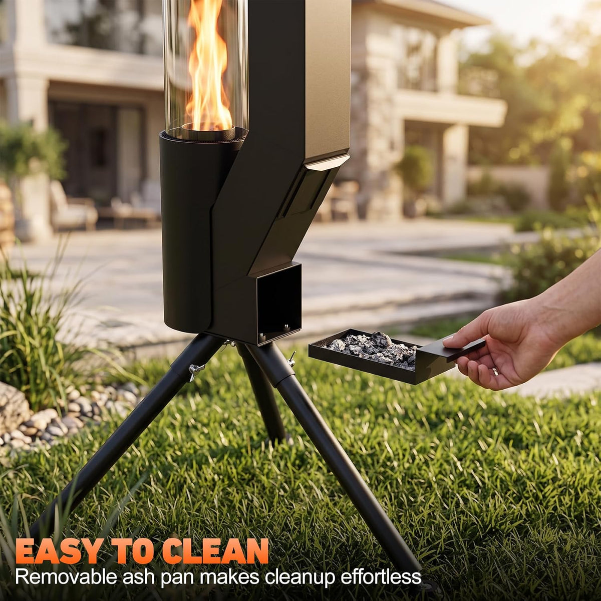 Hand removing a removable ash pan from the heater's base beside its three tripod legs on lawn.