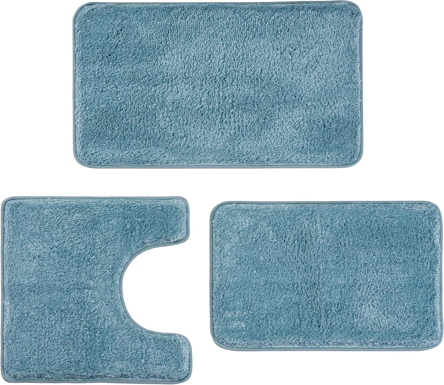 Three-piece bathroom rug set in teal shown flat: rectangular mat, U-shaped toilet mat, and smaller rectangular mat.
