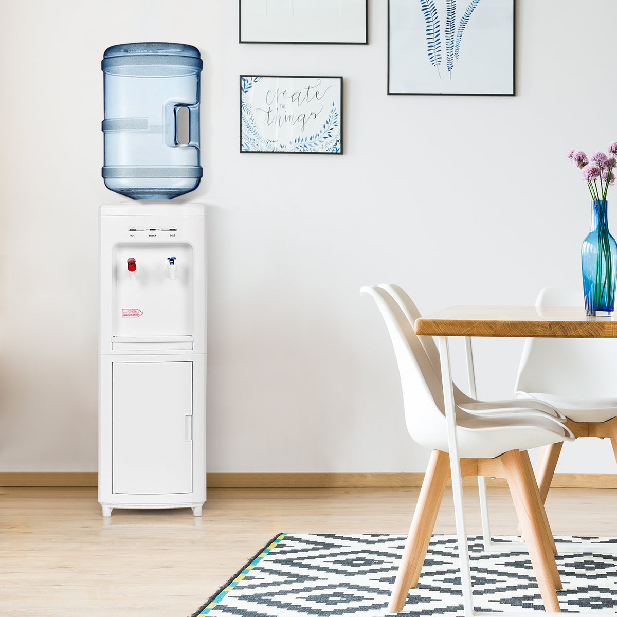 White water cooler with a blue bottle beside a dining table in a bright room.