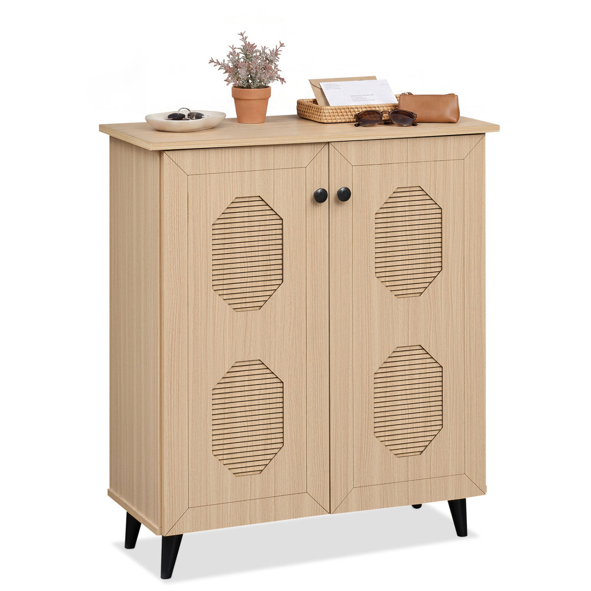 Angled view of the cabinet on a white background, topped with a small plant, tray, and personal items.