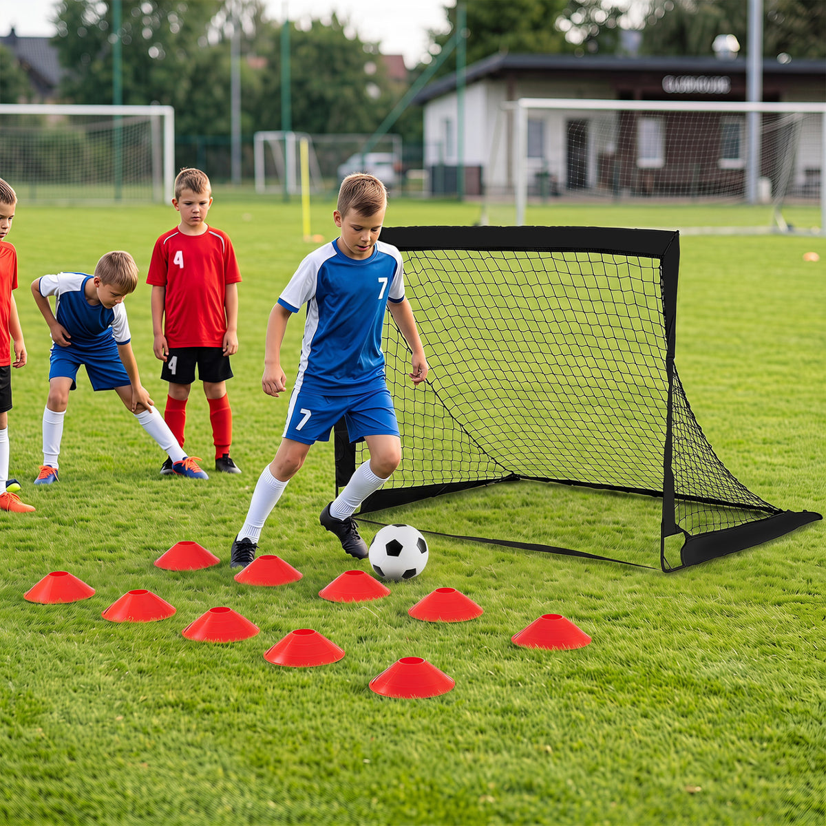 Black soccer goal beside red cones during outdoor soccer practice