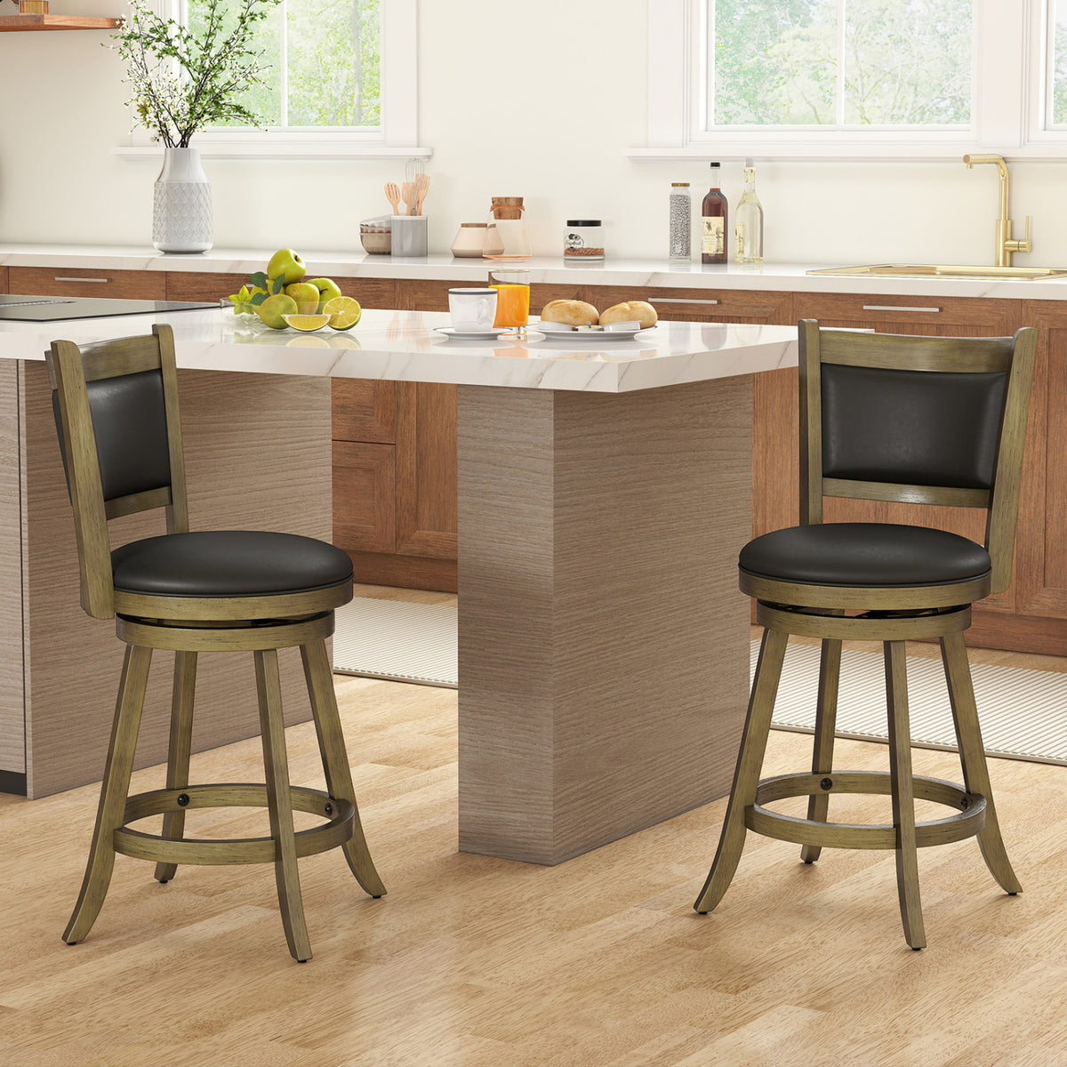 Two dark upholstered swivel stools stand at a kitchen island.