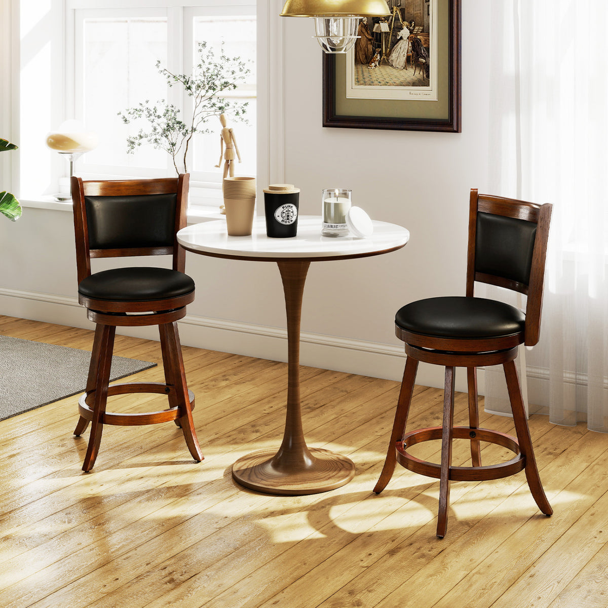 Two dark wood stools with black seats beside a small round table in a sunlit room.