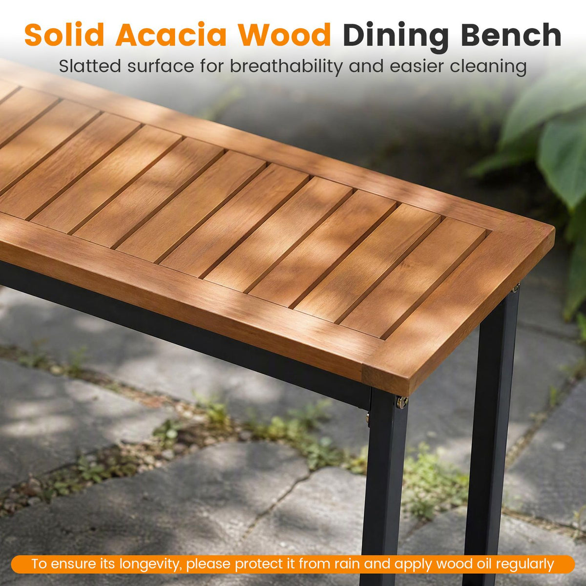 Close view of the bench’s warm-toned slatted wooden seat and black metal legs outdoors.
