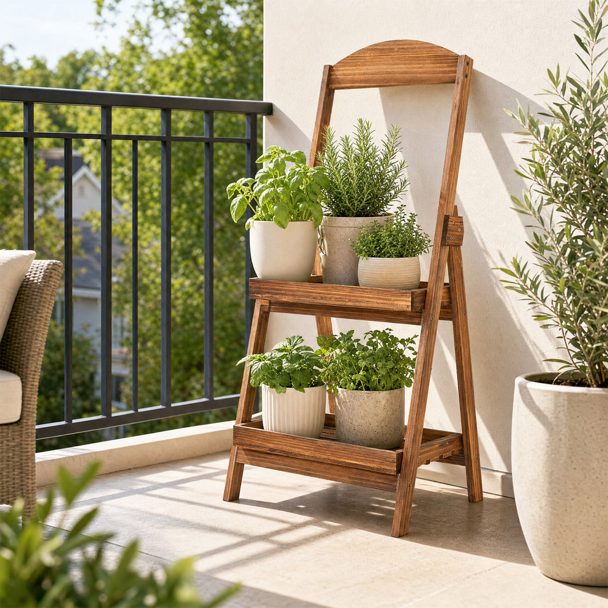 Two-tier wooden ladder shelf holding potted greenery on a sunlit balcony.