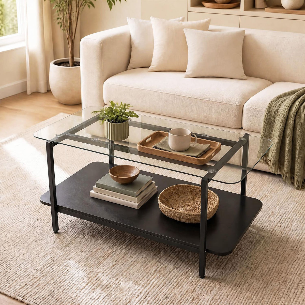 Angled view of black metal and glass coffee table beside a cream sofa