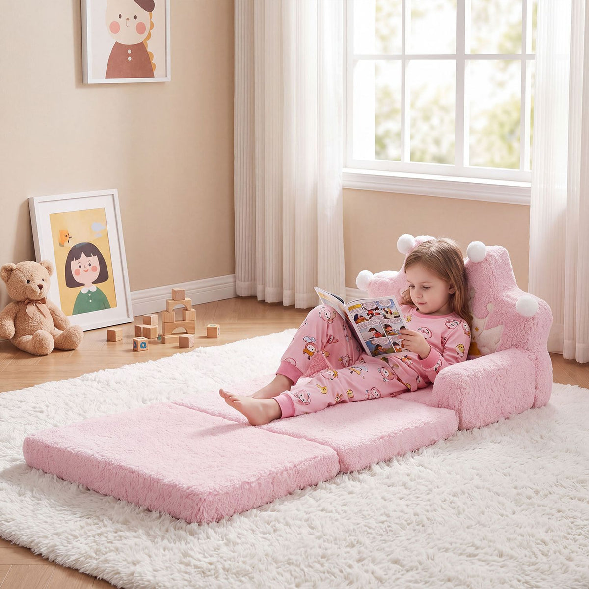 A child reads while reclining on the pink sofa unfolded into a long floor bed.