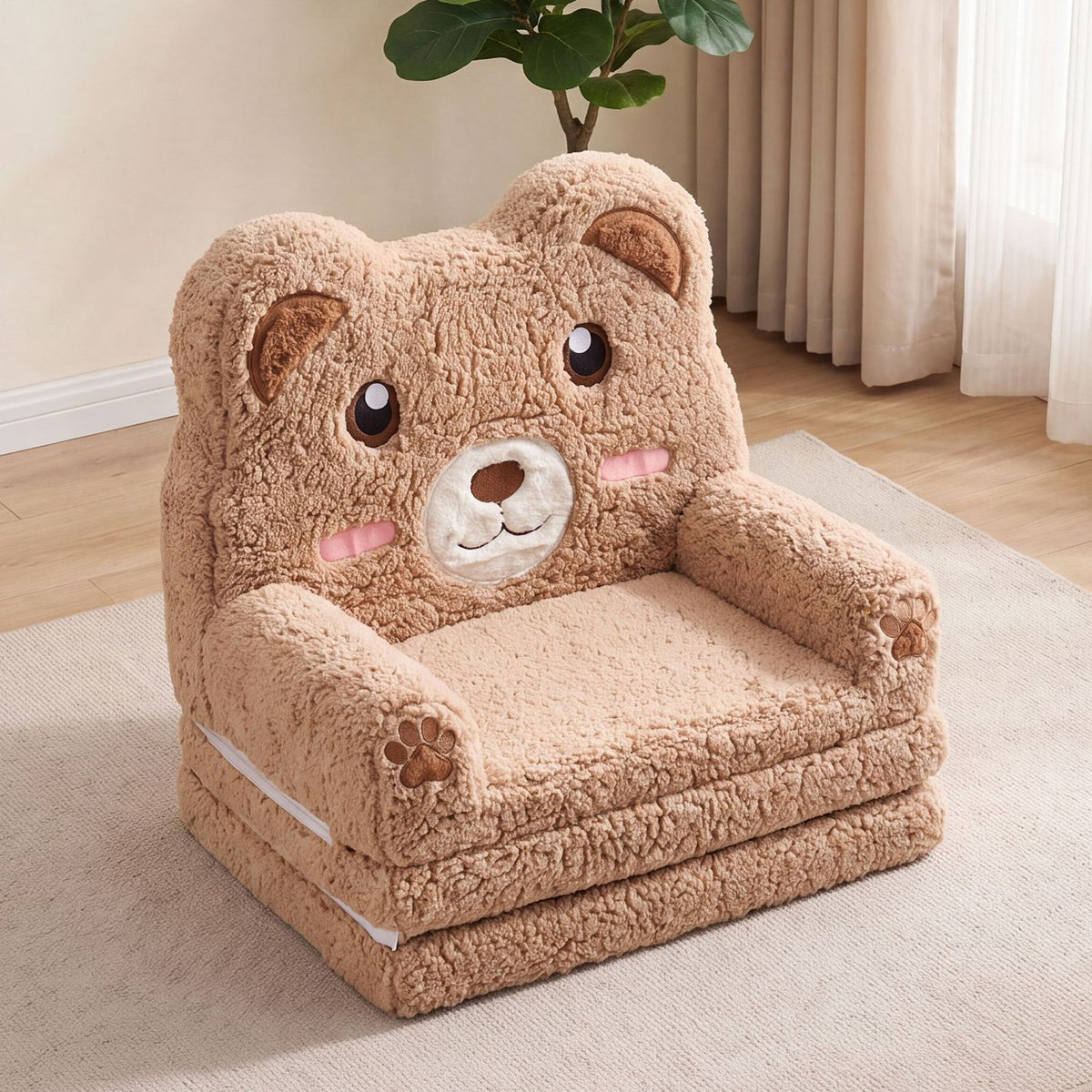 Brown plush bear-shaped children's sofa with armrests on a light rug beside a curtained window.