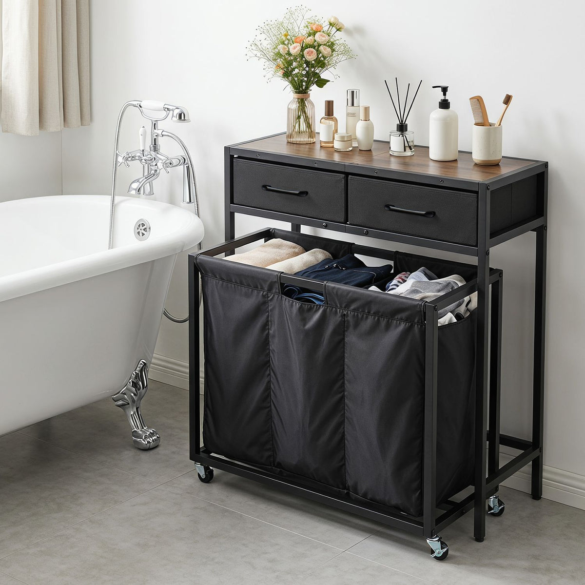 Black laundry sorter console beside a bathtub, with three open fabric sections and two drawers.