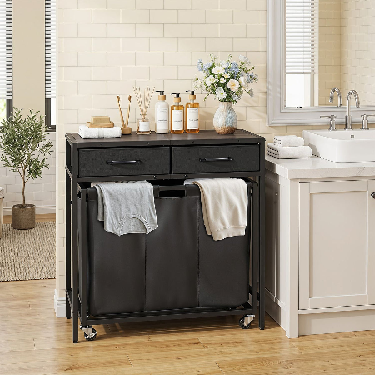 Laundry sorter console in a bathroom, with towels draped over its three fabric compartments.