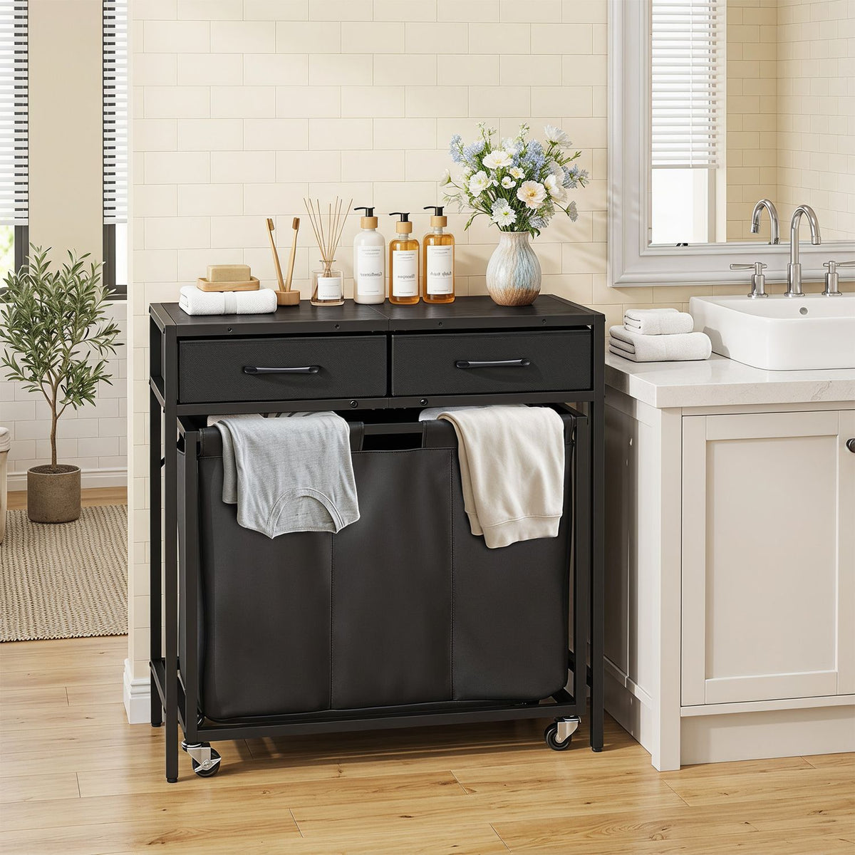 Black laundry console in a bathroom, with towels draped over its fabric compartments and two drawers on top.