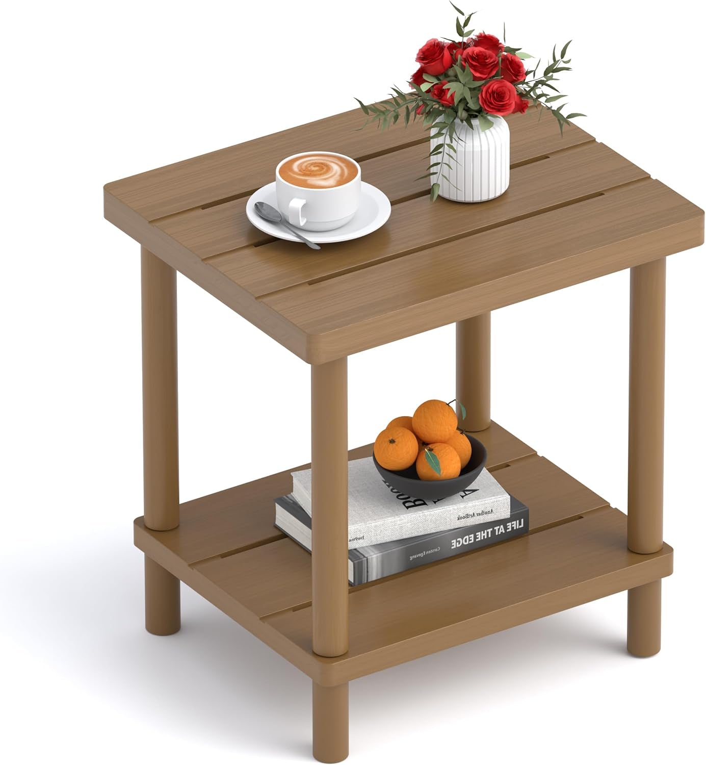 Angled view of a small brown bamboo two-tier side table with a cup and vase on top and books on lower shelf.