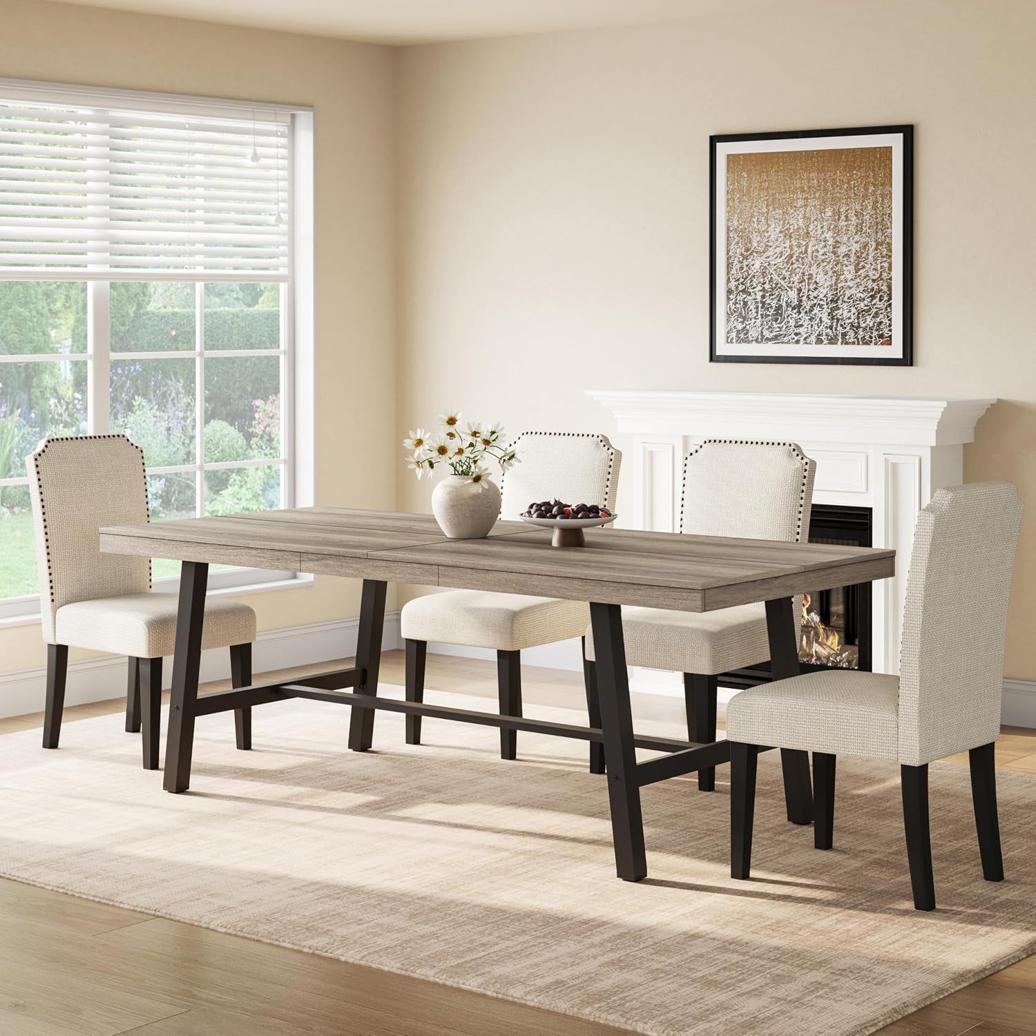 Styled dining room scene showing the rectangular table with four upholstered chairs and a vase centerpiece.