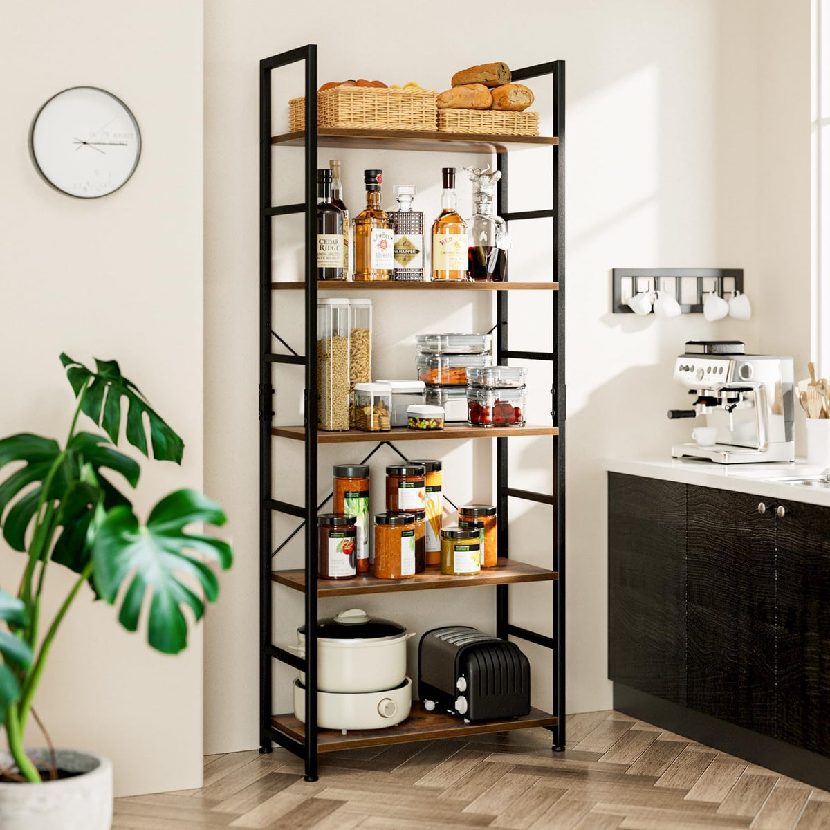 Five-tier wood-tone shelves and black frame placed in a kitchen corner, styled with pantry jars and small appliances.