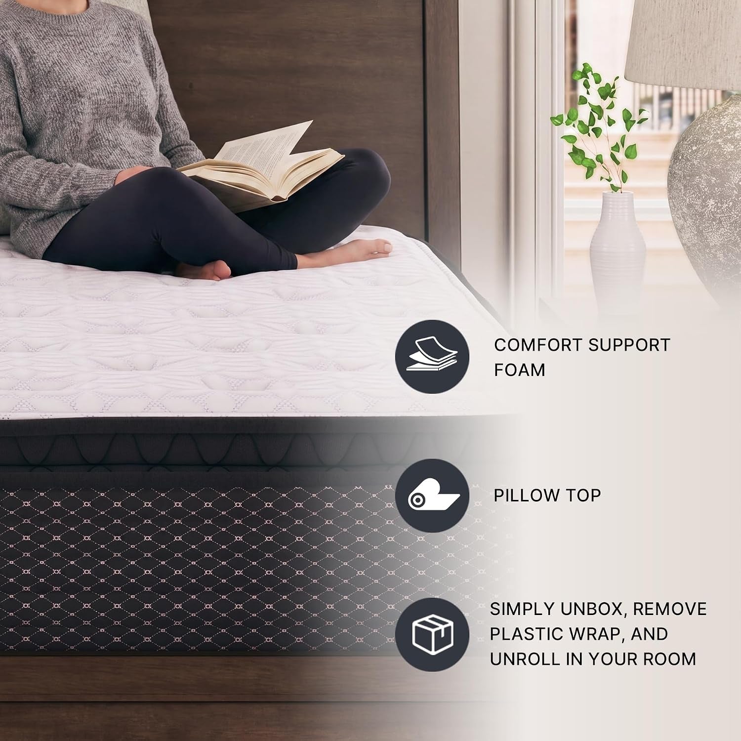 Person sitting cross-legged on a made bed reading a book, showing the mattress top and bedside decor with icons.