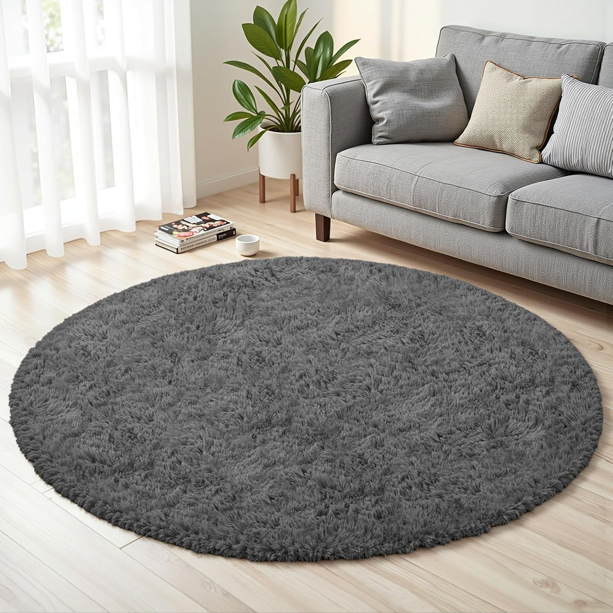 Round dark gray shag rug under a gray sofa in a bright living room