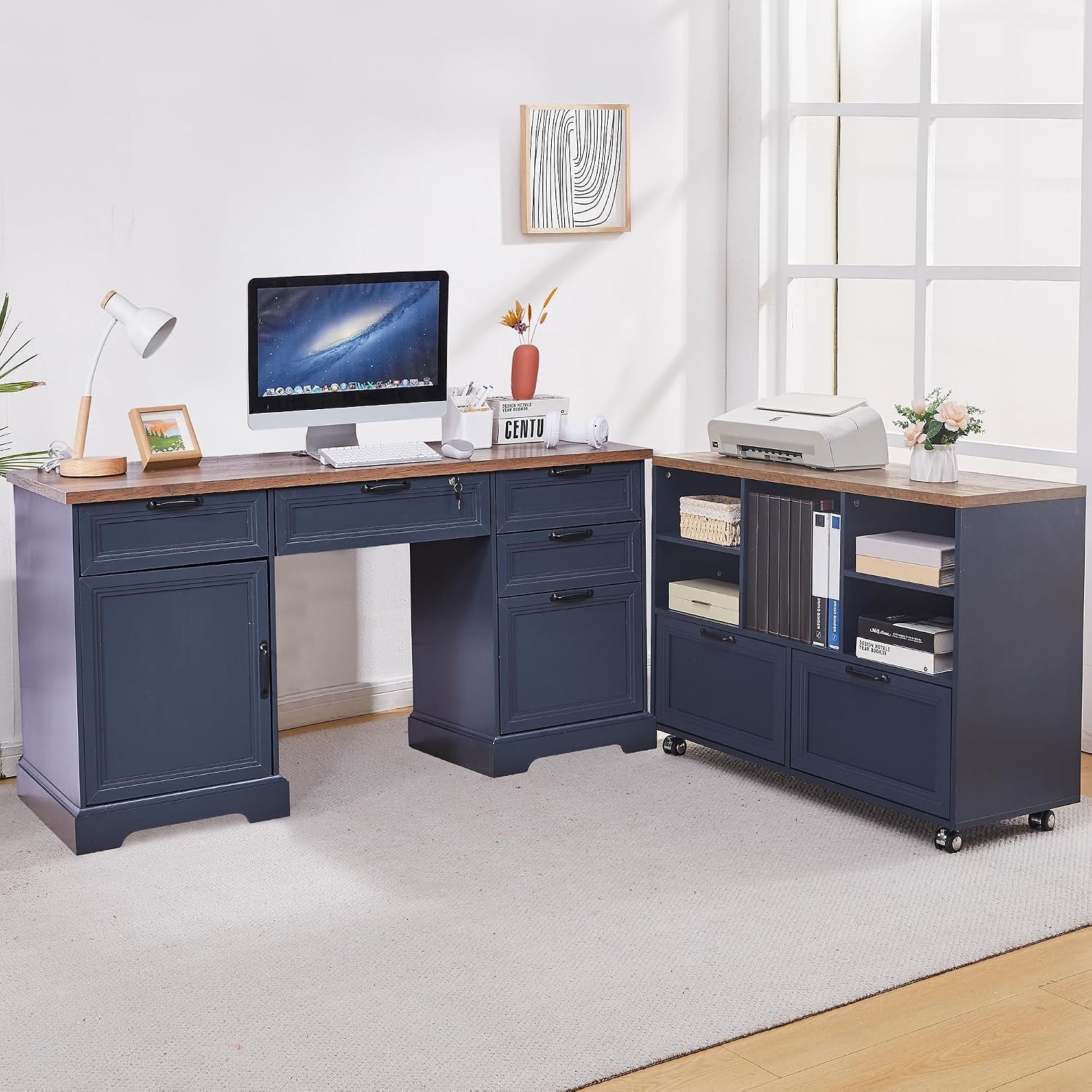 Navy blue L-shaped desk set with wood top placed by a bright window, printer and vase on the cabinet