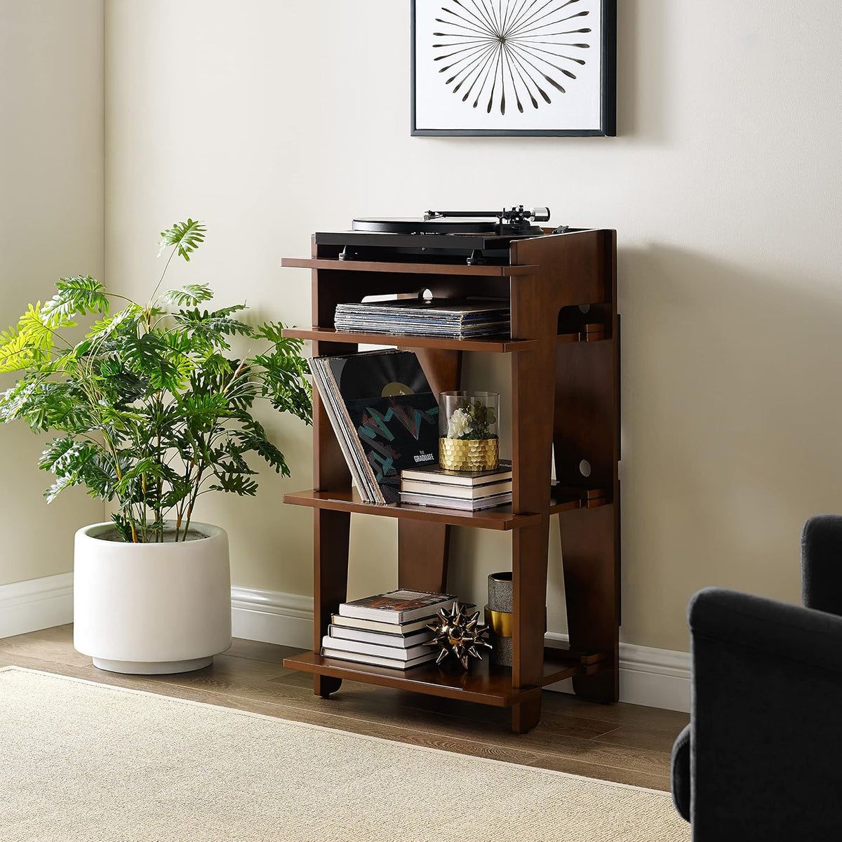 Mahogany record stand styled in a living room with a turntable on top and plants nearby.