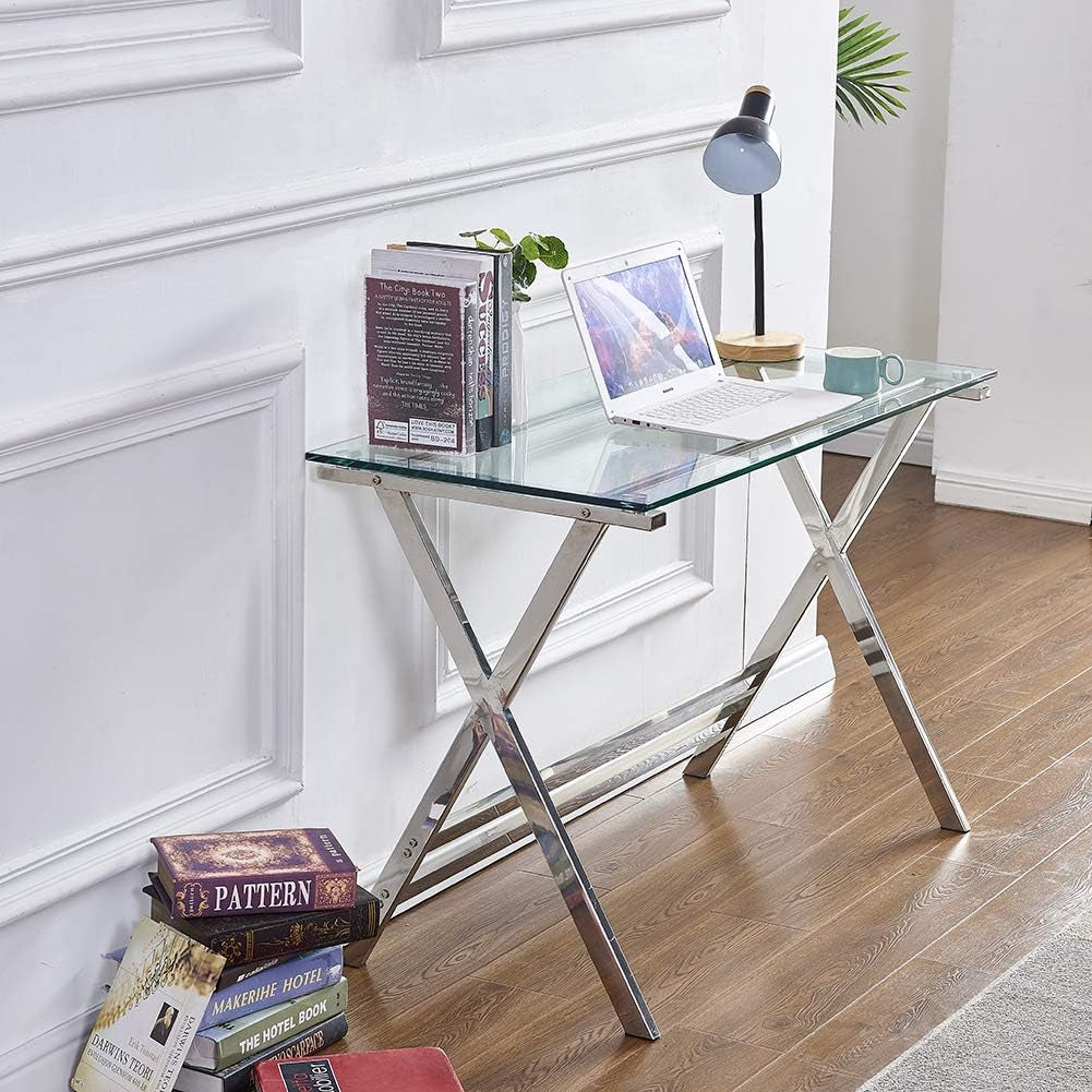 Right-side angled view showing the X-frame legs, lower support rails, and stacked books on the floor nearby.