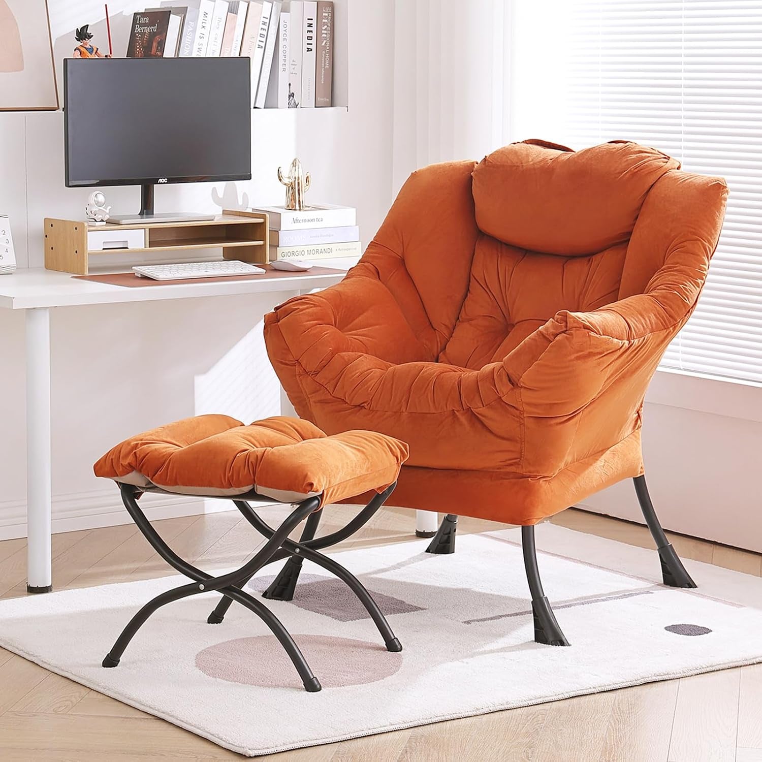 Rust-orange cushioned lounge chair with matching ottoman in a home office setting