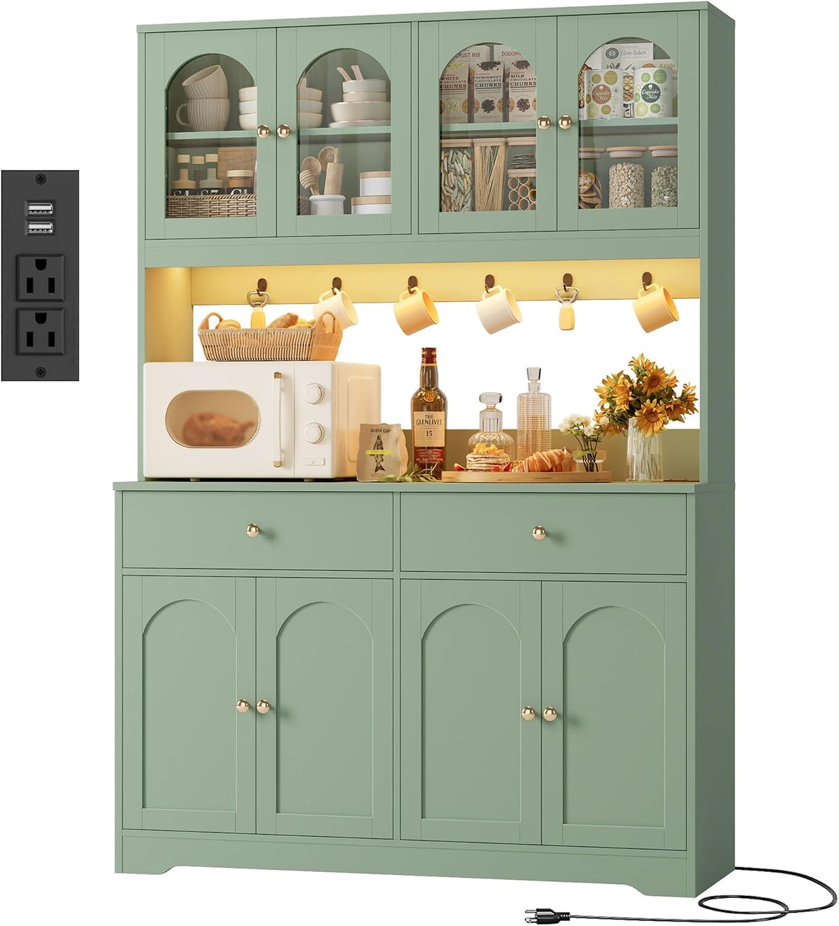 Tall green pantry hutch shown front-on with microwave, hanging mugs and sunflowers on the counter