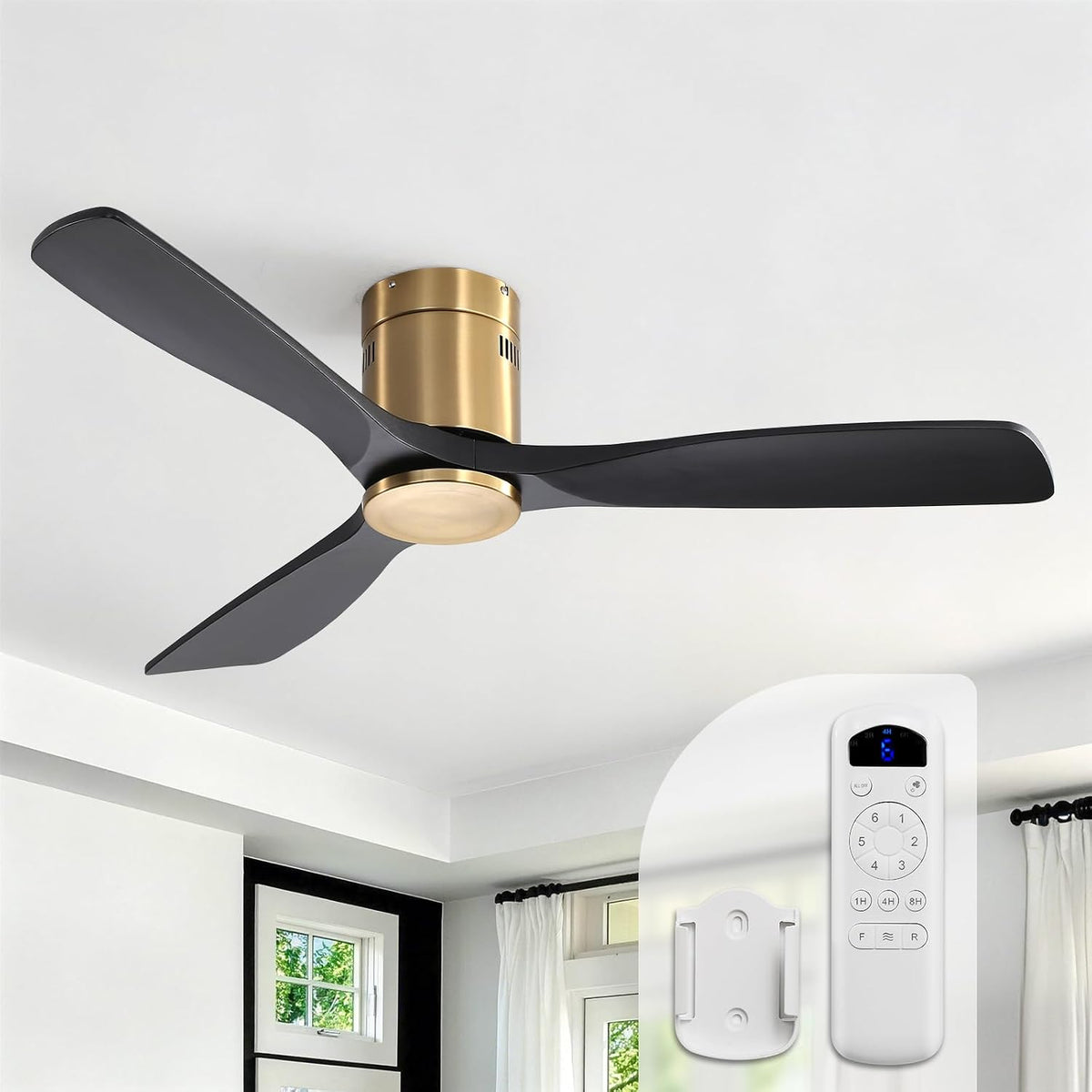 Flush‑mount fan with dark blades and brushed gold motor installed on a white ceiling, remote shown