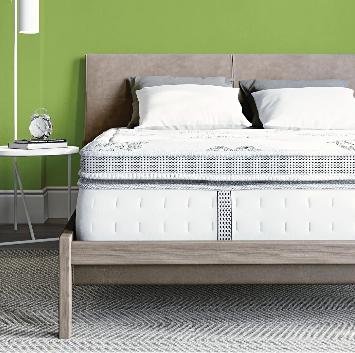 White pillow-top hybrid mattress front view on a light wood platform with knit side panels visible