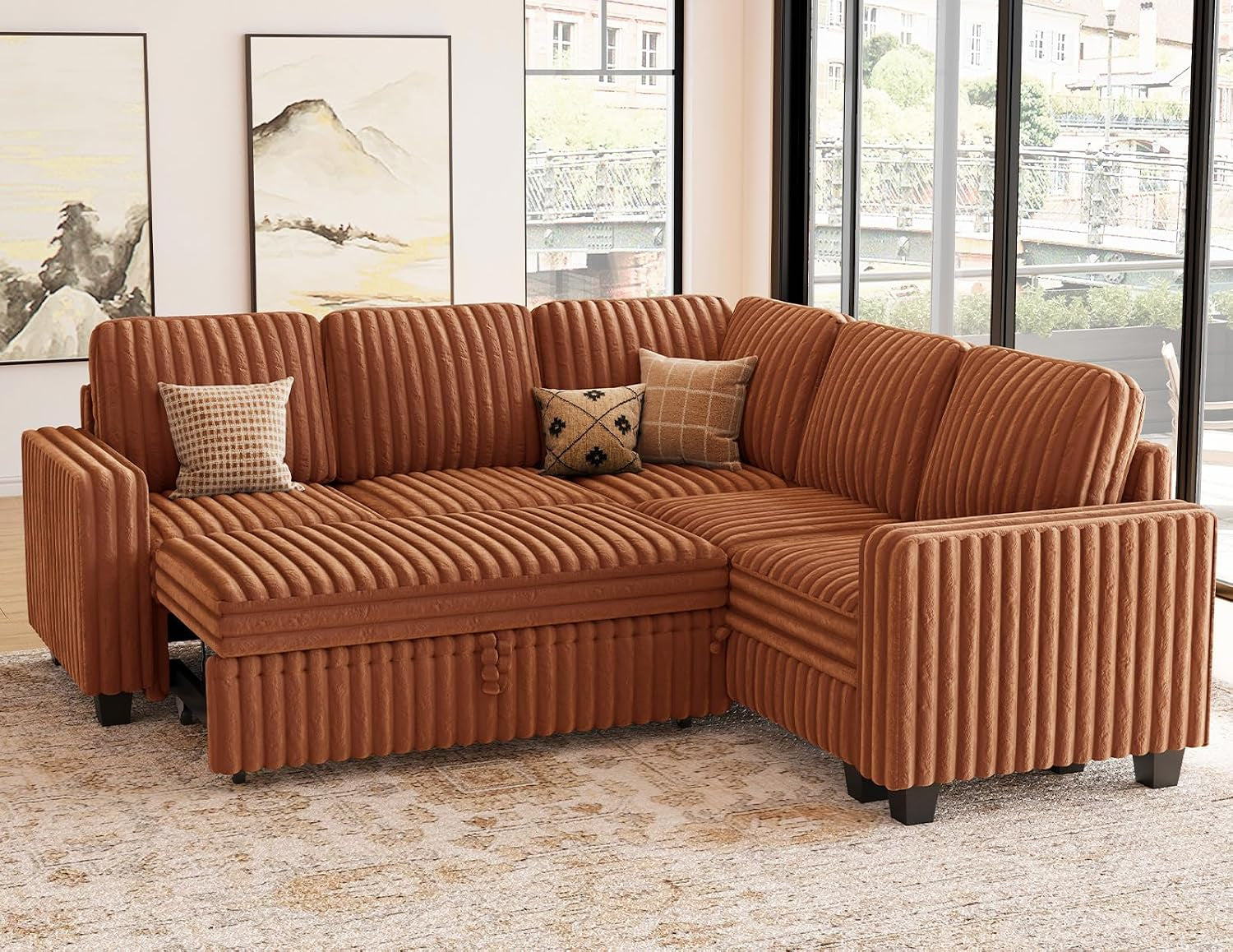 Three-quarter view of a rust-colored corduroy modular sectional arranged as a right-hand chaise in a sunlit room