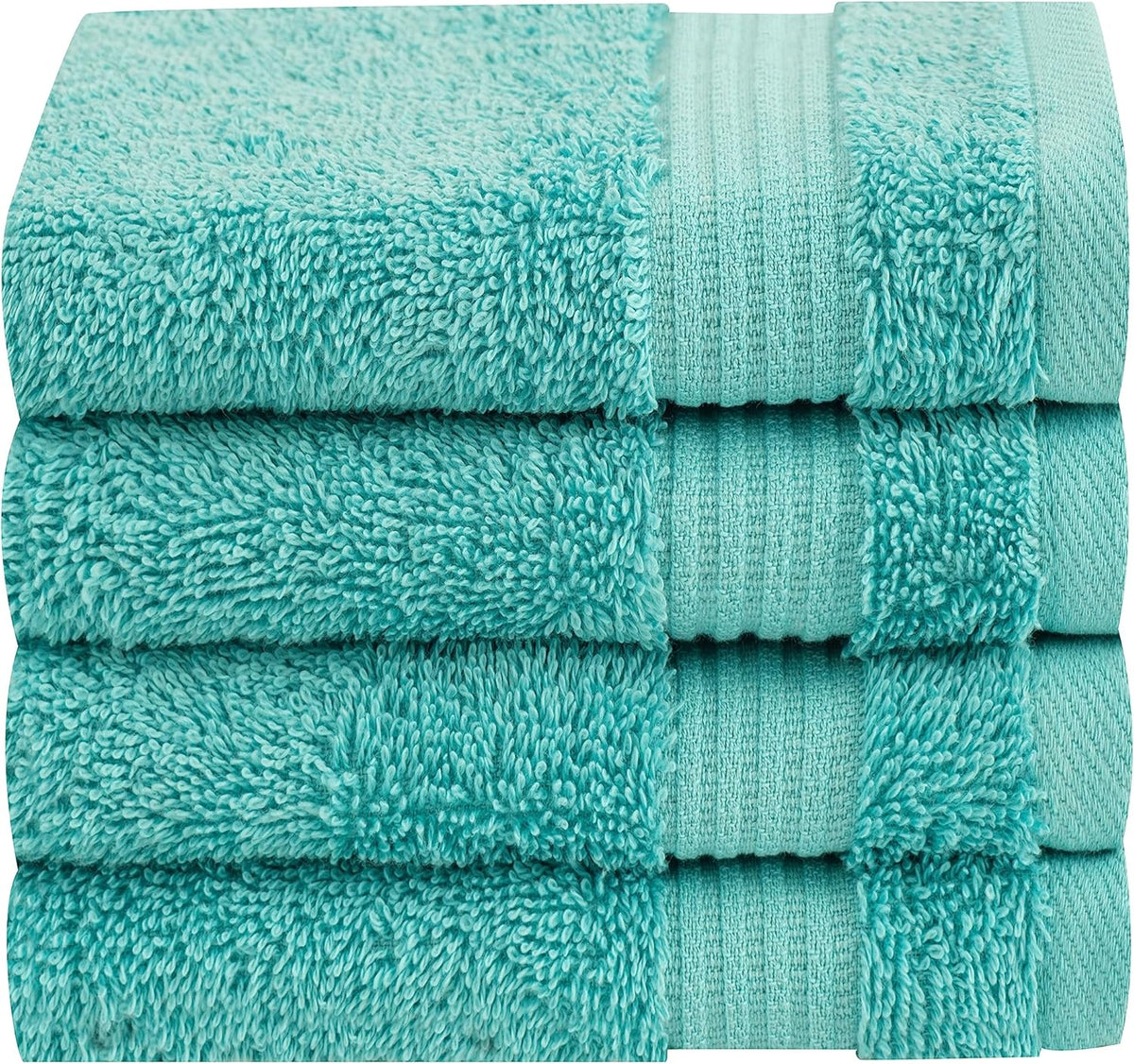 Close-up side view of four tightly stacked light aqua towels showing looped terry texture.