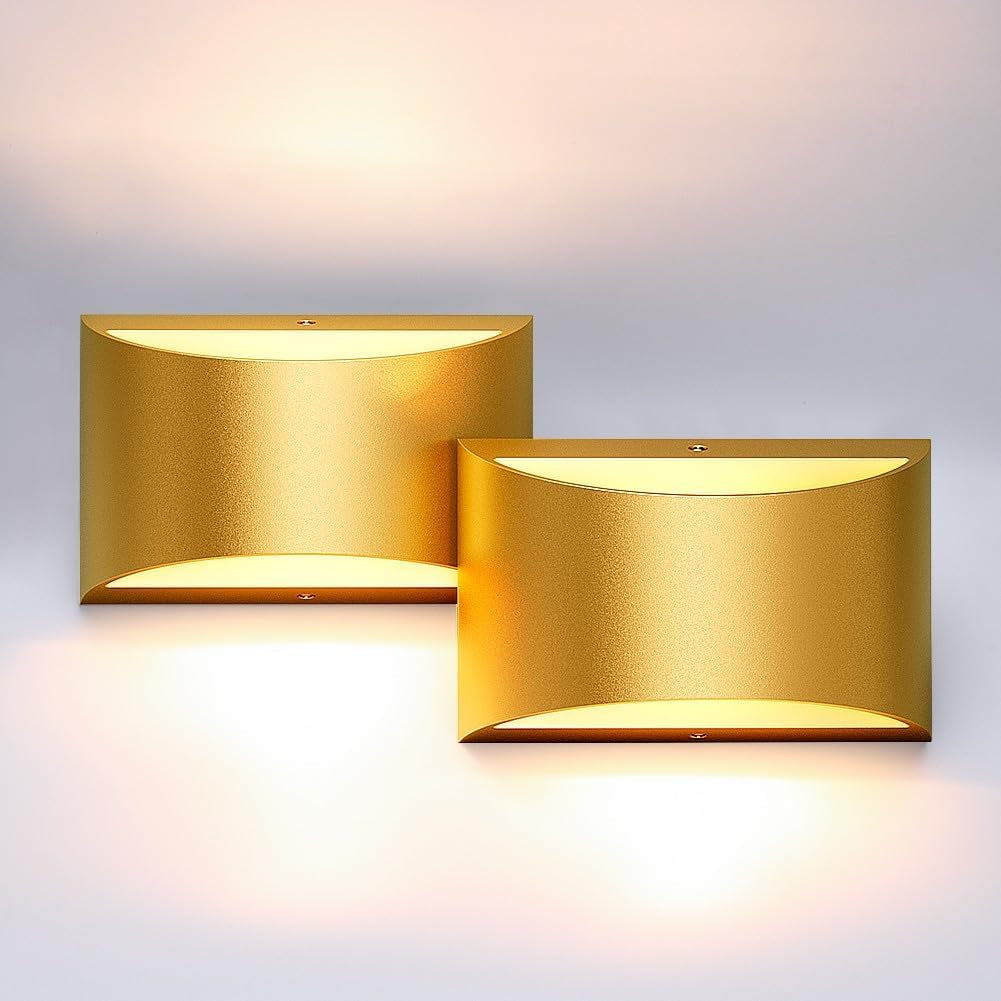 Two overlapping rectangular wall lights with a gold finish, emitting warm up-and-down lighting on the wall.
