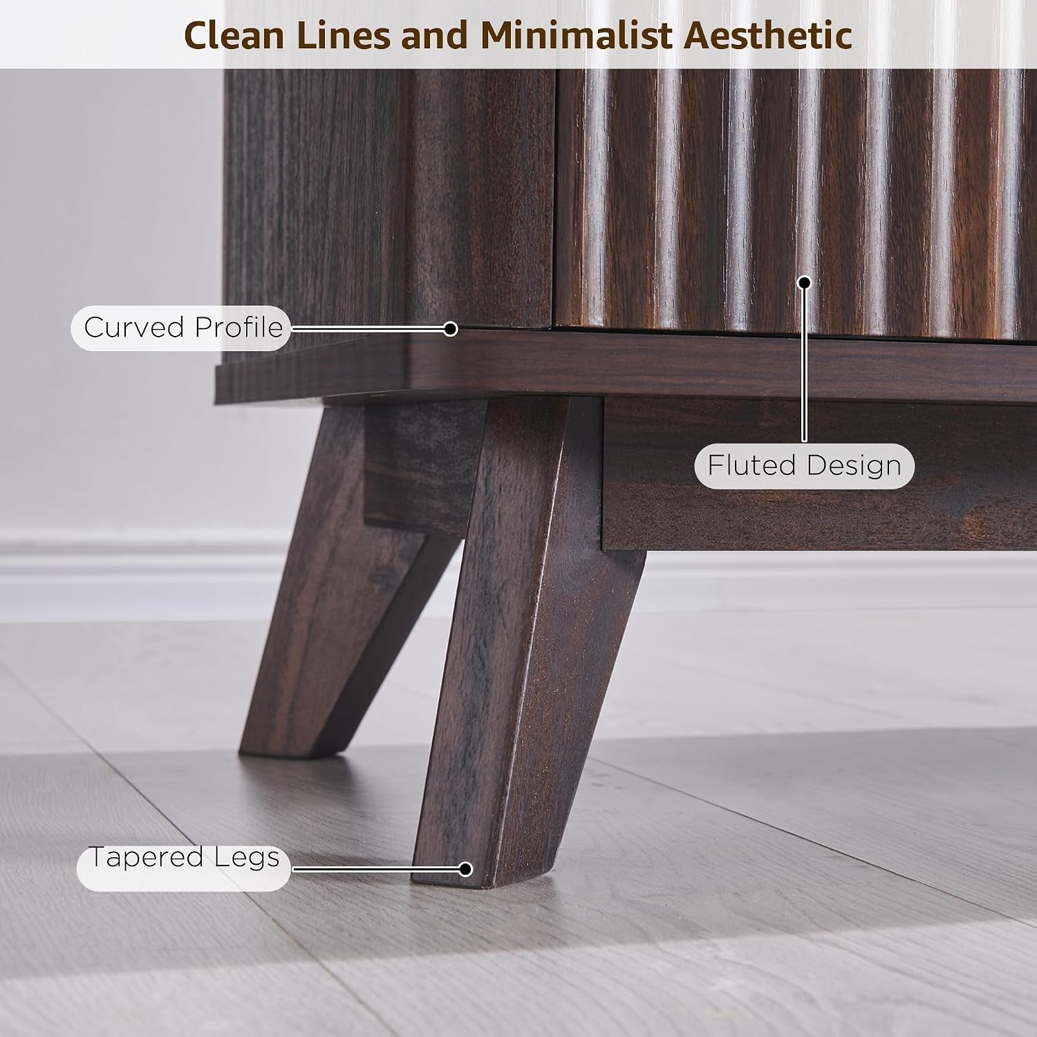Detail close-up of tapered leg and vertical fluted door grooves on a dark walnut TV stand