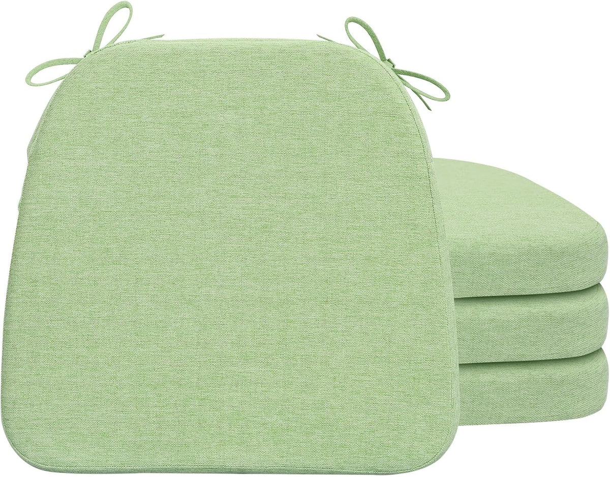 Stacked D‑shaped chair pads in a light green woven fabric shown from front and side with ties