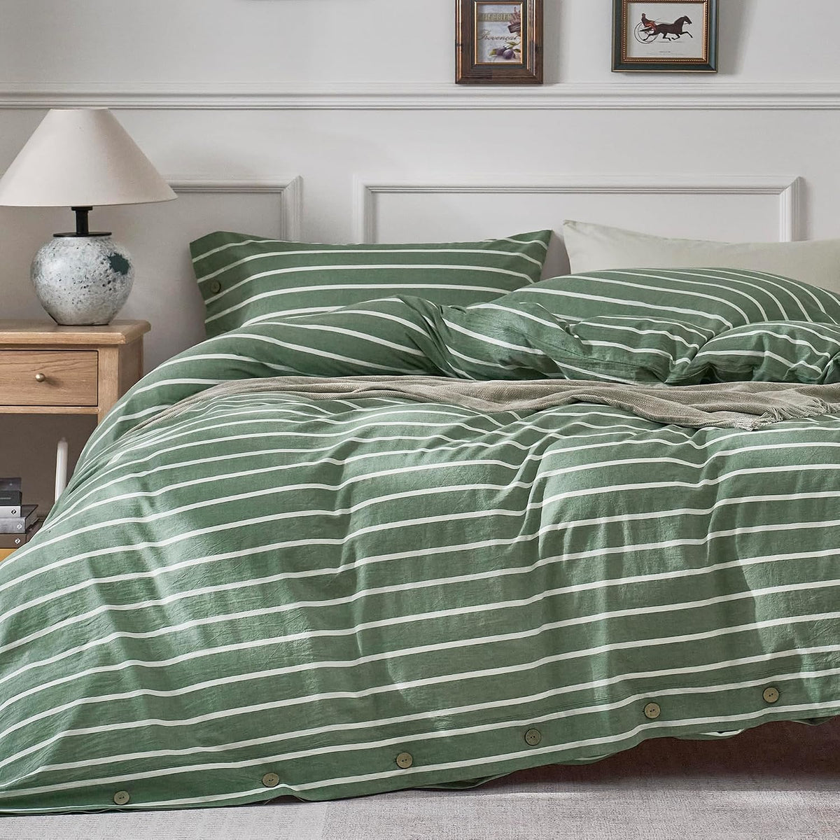 Striped green and white duvet cover draped over bed showing horizontal stripes and wooden buttons