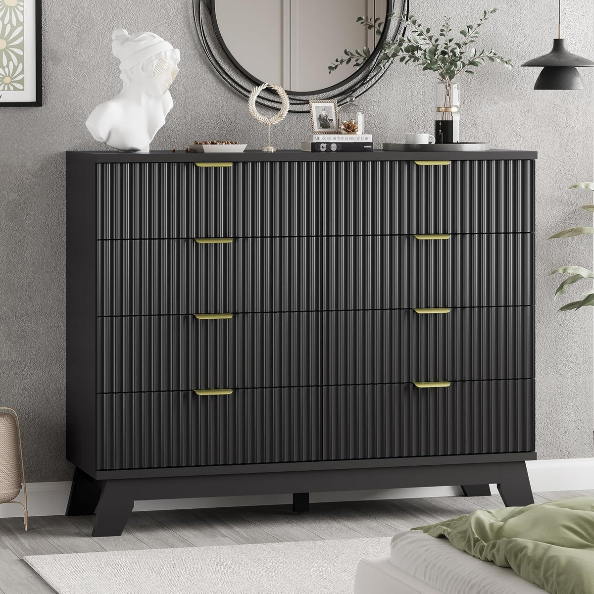 Close view of a black ribbed-front dresser showing the textured drawer faces and angled wooden base.