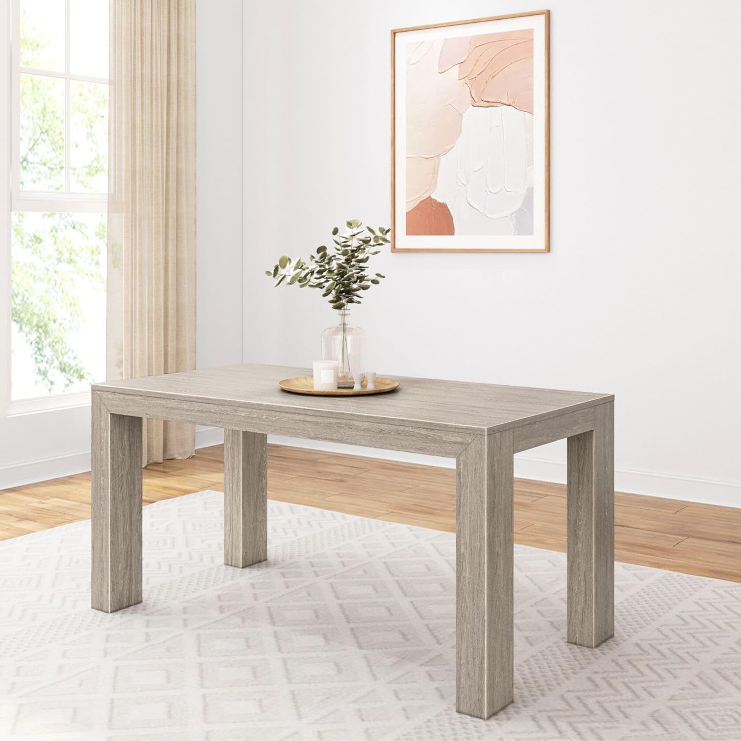 Rectangular solid pine dining table in light gray finish with decorative tray and vase