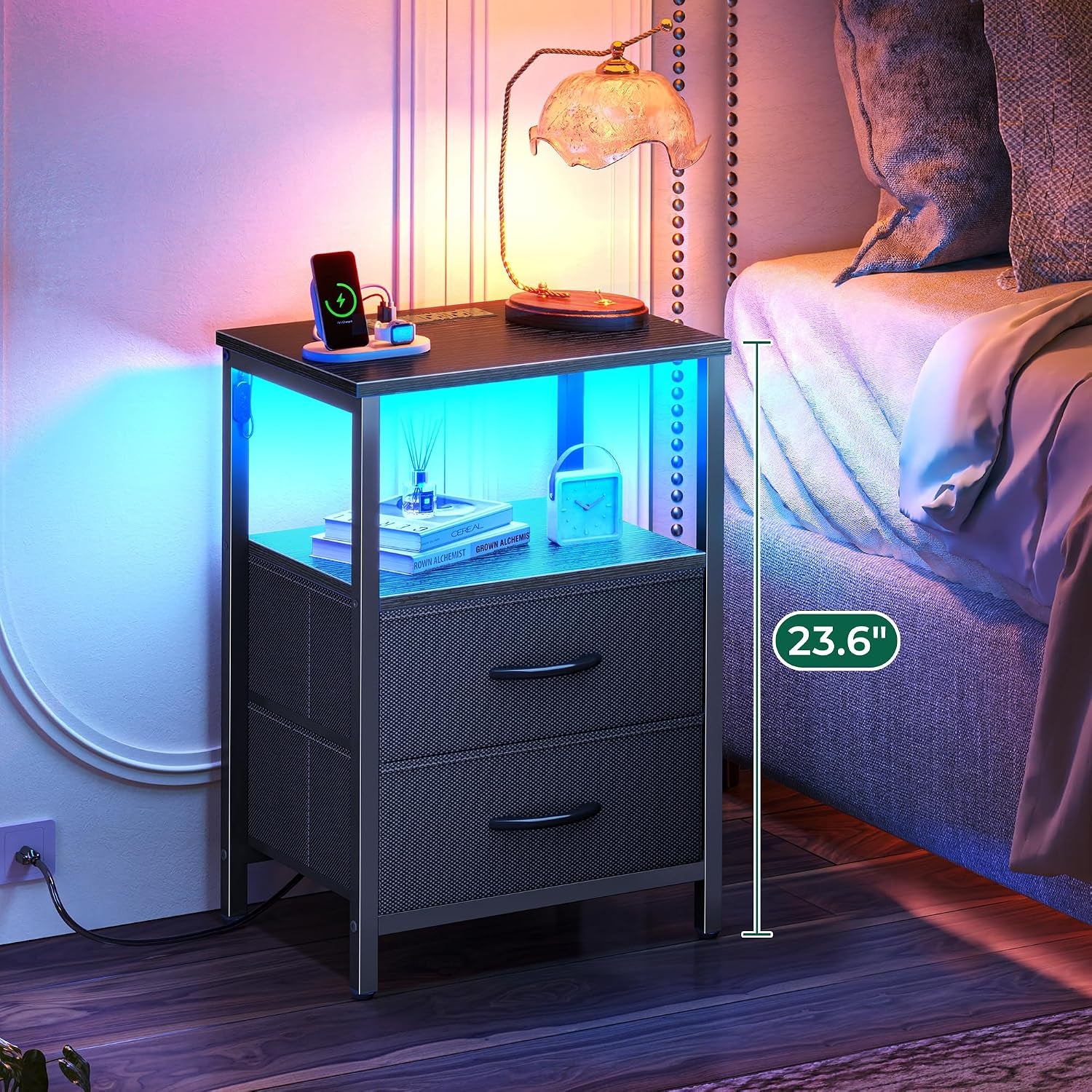 Black nightstand beside bed with blue LED lighting in the open shelf and cord visible to outlet