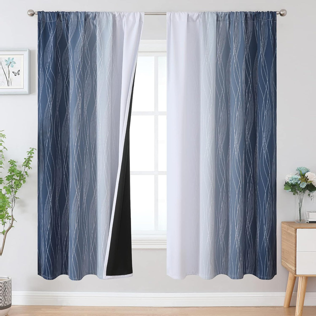 Window with two ombre curtains in navy to white gradient, one panel opened exposing black backing