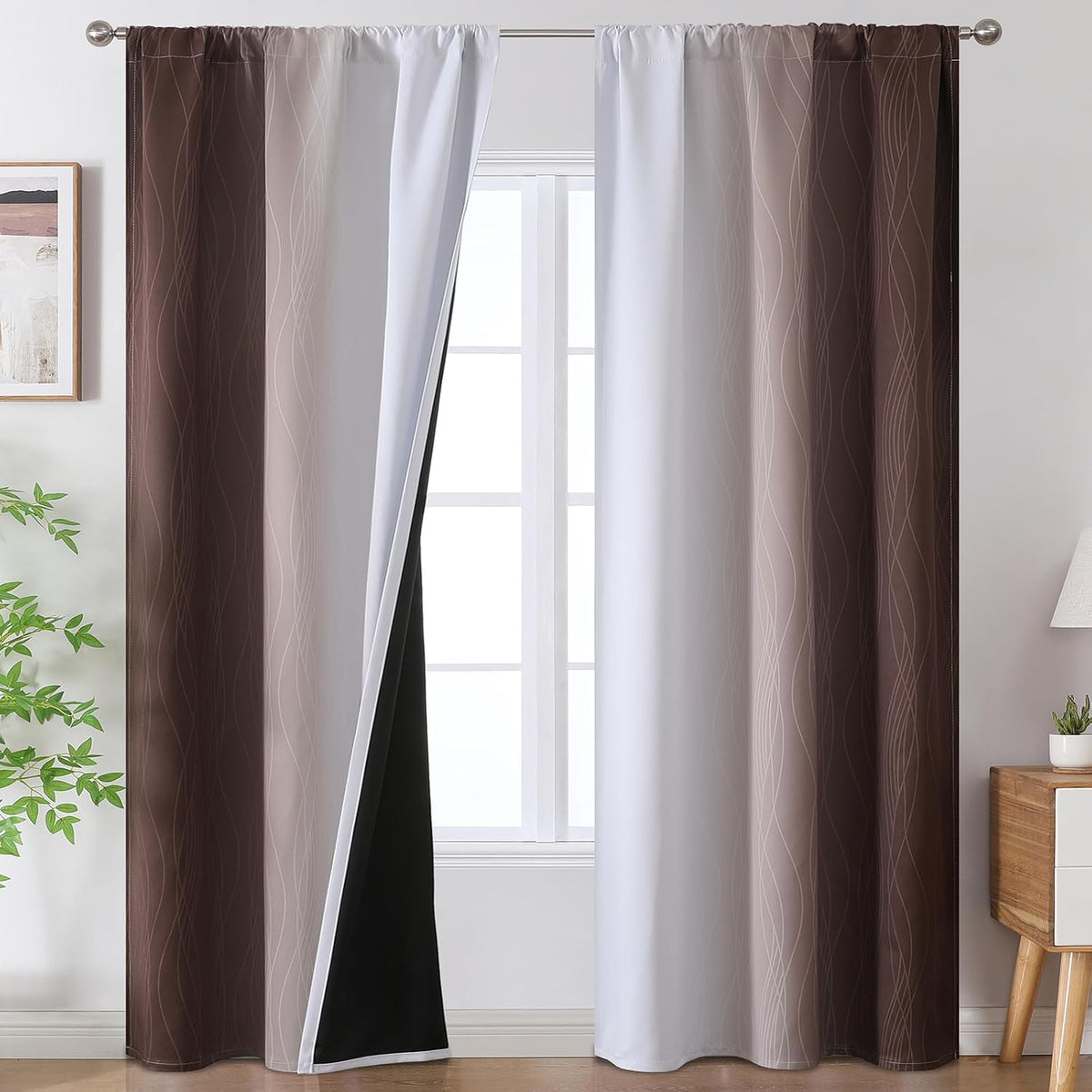 Window with brown-to-white ombre curtain panels featuring thin wavy lines and a dark blackout lining inside