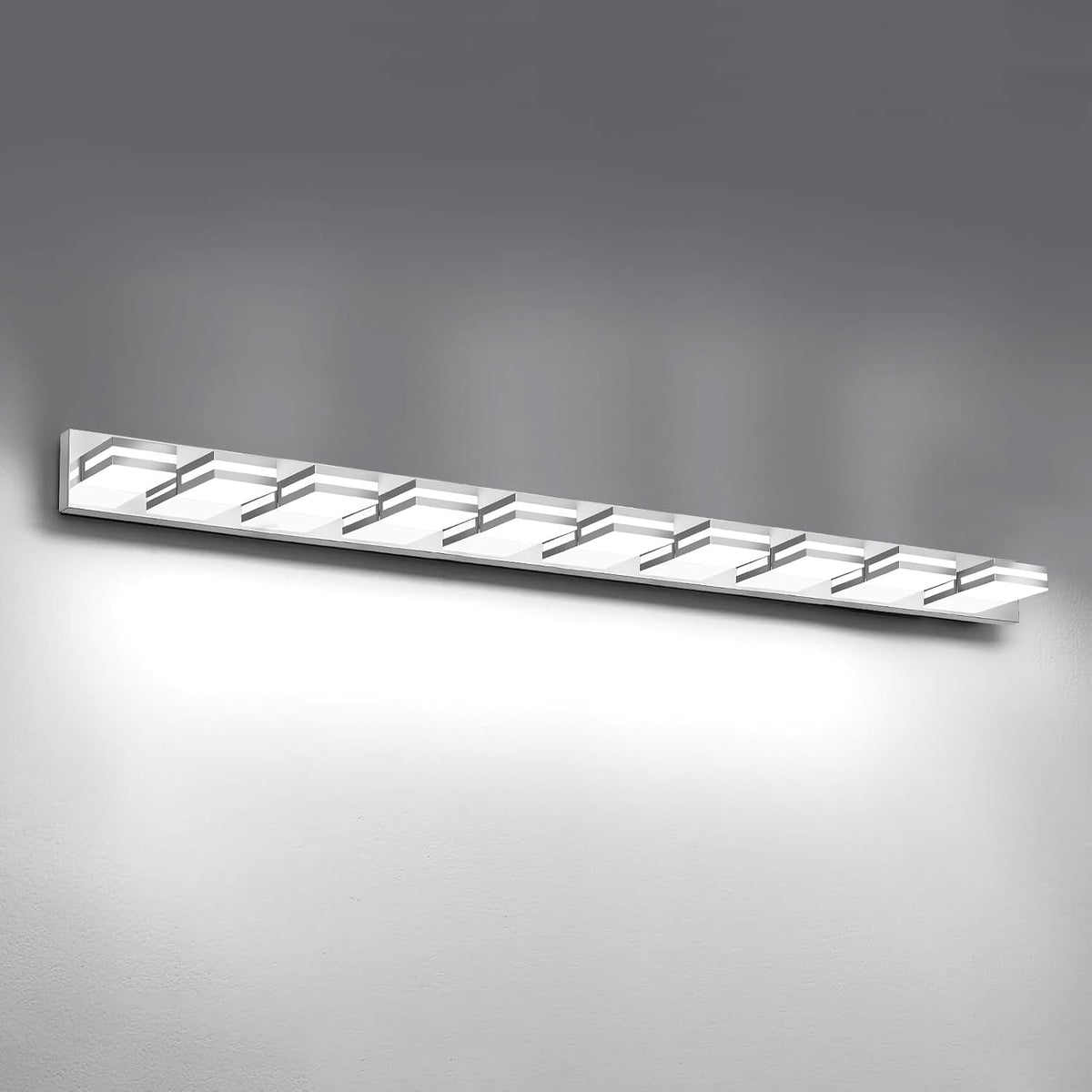 Wider frontal view of the silver LED vanity bar mounted on a light gray wall, showing all six illuminated squares.