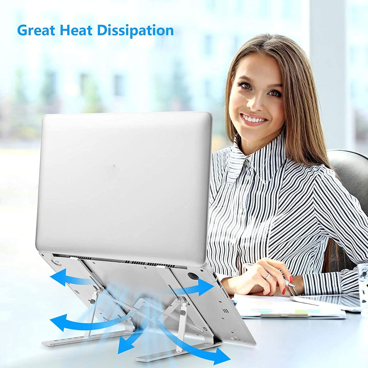 Smiling woman at a desk using a silver laptop elevated on the stand with blue airflow arrows.