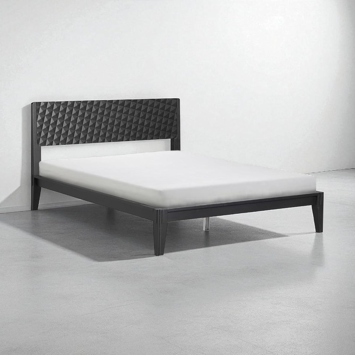 Low-profile black bed shown from an angle, highlighting legs and simple platform frame