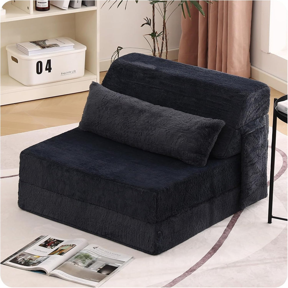 Dark charcoal folding floor sofa set up as a single-seat chair with matching lumbar pillow in a living room.