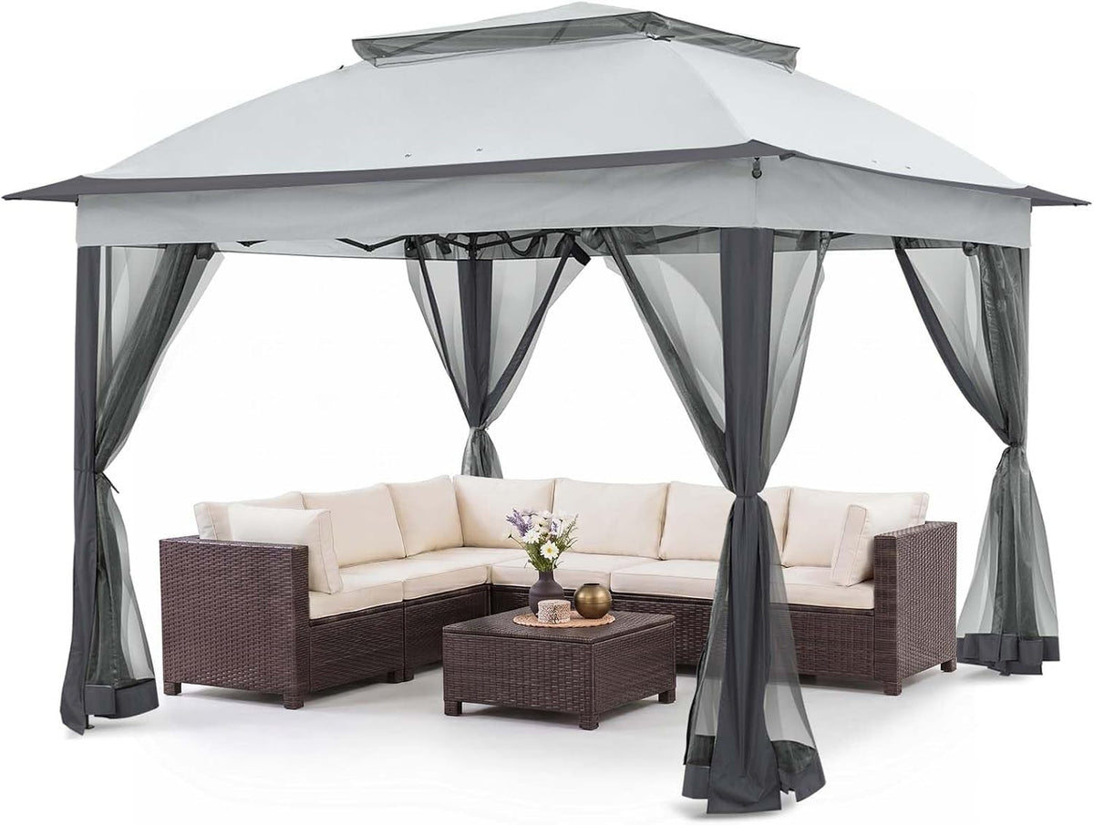 Light gray pop-up gazebo with sheer mesh curtains tied back over outdoor sectional set.