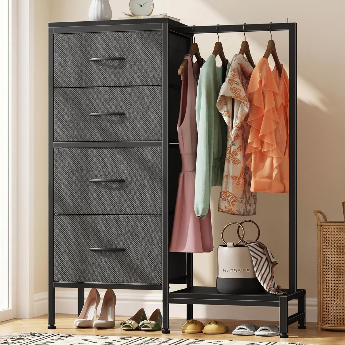 Black-framed tall dresser with textured drawer fronts, adjacent hanging rail with clothes and shoes on lower shelf.