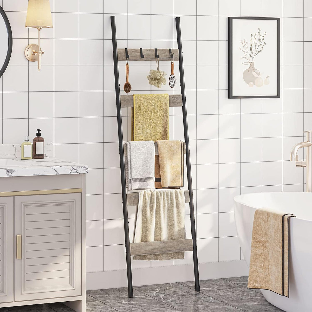 Leaning towel ladder with black tubular frame and light wood slats against a white tiled bathroom wall with towels hung