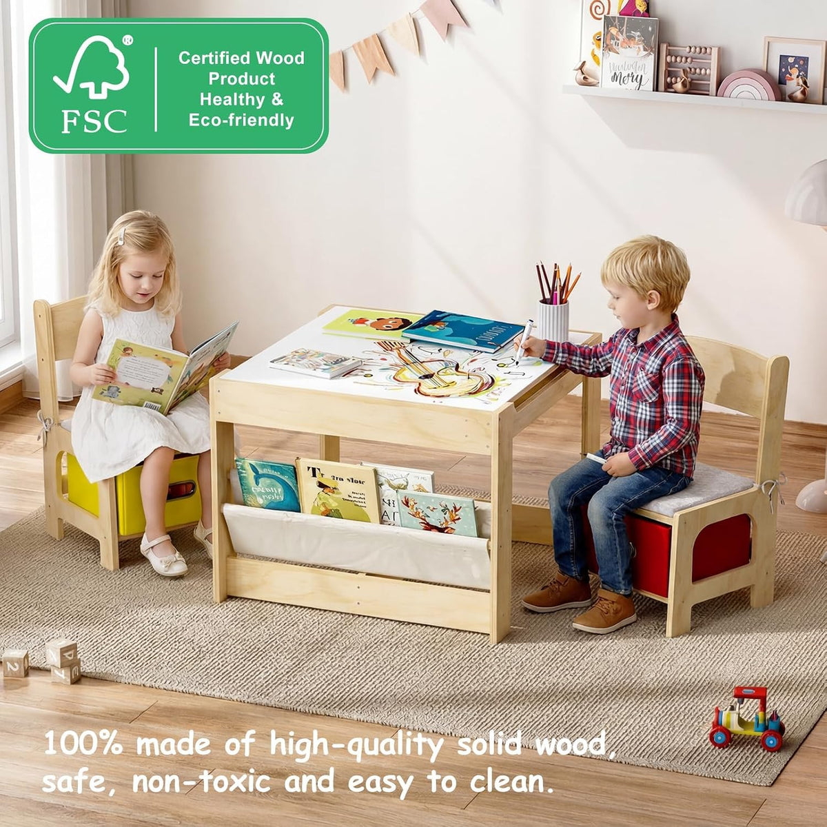 Two children sitting at a rectangular wooden activity table with books, pencils and storage pockets underneath.